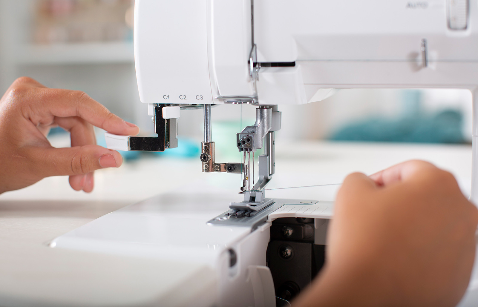 Image of Maker Threading The Needles on a Baby Lock Serger